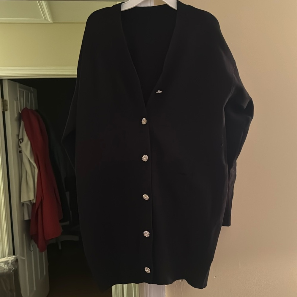 Women’s black sweater with Rhinestone buttons.